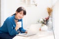 Beautiful young freelance asian woman smiling working and on laptop computer at desk coffee shop with professional Royalty Free Stock Photo