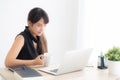 Beautiful young freelance asian woman smiling working and on laptop computer at desk office with professional