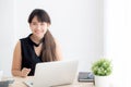 Beautiful young freelance asian woman smiling working and typing on laptop computer at desk office with professional Royalty Free Stock Photo