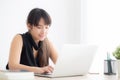 Beautiful young freelance asian woman smiling working and typing on laptop computer at desk office with professional Royalty Free Stock Photo