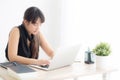 Beautiful young freelance asian woman smiling working and typing on laptop computer at desk office with professional Royalty Free Stock Photo