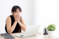 Beautiful young freelance asian woman working bored and tired on laptop computer at the office Royalty Free Stock Photo