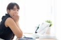 Beautiful young freelance asian woman working bored and tired on laptop computer at the office. Royalty Free Stock Photo