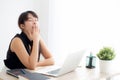 Beautiful young freelance asian woman working bored and tired on laptop computer at the office Royalty Free Stock Photo