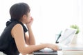 Beautiful young freelance asian woman working bored and tired on laptop computer at the office, girl lazy sleepy and yawning Royalty Free Stock Photo