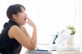 Beautiful young freelance asian woman working bored and tired on laptop computer at the office Royalty Free Stock Photo