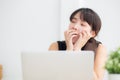 Beautiful young freelance asian woman working bored and tired on laptop computer at the office Royalty Free Stock Photo