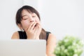 Beautiful young freelance asian woman working bored and tired on laptop computer at the office. Royalty Free Stock Photo