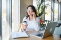 Beautiful Young Freelancer Woman Using Laptop Computer Sitting At Cafe Table. Happy Smiling Girl Working Online Or Royalty Free Stock Photo