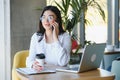 Beautiful Young Freelancer Woman Using Laptop Computer Sitting At Cafe Table. Happy Smiling Girl Working Online Or Royalty Free Stock Photo