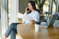 Beautiful Young Freelancer Woman Using Laptop Computer Sitting At Cafe Table. Happy Smiling Girl Working Online Or Royalty Free Stock Photo