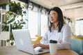 Beautiful Young Freelancer Woman Using Laptop Computer Sitting At Cafe Table. Happy Smiling Girl Working Online Or Royalty Free Stock Photo