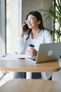 Beautiful Young Freelancer Woman Using Laptop Computer Sitting At Cafe Table. Happy Smiling Girl Working Online Or Royalty Free Stock Photo