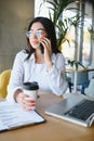 Beautiful Young Freelancer Woman Using Laptop Computer Sitting At Cafe Table. Happy Smiling Girl Working Online Or Royalty Free Stock Photo