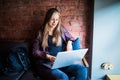 Beautiful Young Freelancer Woman Using Laptop Computer Sitting At Cafe Table. Happy Smiling Girl Working Online Or Studying And Le Royalty Free Stock Photo