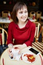 French woman drinking coffee in Parisian outdoor cafe Royalty Free Stock Photo