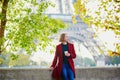 Beautiful young French woman near the Eiffel tower in Paris