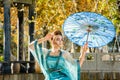 Beautiful young geisha with a blue umbrella Royalty Free Stock Photo