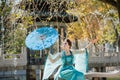 Beautiful young geisha with a blue umbrella Royalty Free Stock Photo