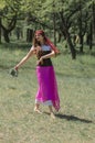 Beautiful young girl dancing in the forest