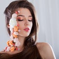 Beautiful young girl with applique flowers on the face. Royalty Free Stock Photo