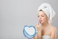 Beautiful young girl applying lipstick in the mirror Royalty Free Stock Photo