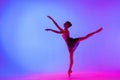 Beautiful young girl ballerina in pointe shoes and pink leotard silhouette on bright blue background Royalty Free Stock Photo