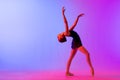 Beautiful young girl ballerina in pointe shoes and pink leotard silhouette on bright blue background Royalty Free Stock Photo