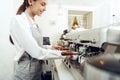 Beautiful young girl barista preparing coffee Royalty Free Stock Photo