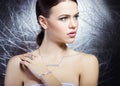 Beautiful young girl with beautiful stylish expensive jewelry, necklace, earrings, bracelet, ring, filming in the Studio Royalty Free Stock Photo