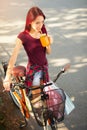 Beautiful young girl with a bicycle in the city Royalty Free Stock Photo