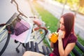 Beautiful young girl with a bicycle in the city Royalty Free Stock Photo