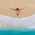 Beautiful young girl in bikini on a tropical beach. Blue sea in Royalty Free Stock Photo