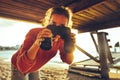 Beautiful young girl with binoculars on the beach at sunset, front view Royalty Free Stock Photo