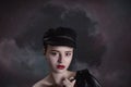 Beautiful young girl in a black cap and leather jacket in the ha Royalty Free Stock Photo