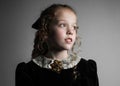 Beautiful young girl in black 1890s English Victorian 18th century child period dress elegant white lace collar antique broach