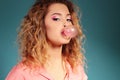 Beautiful young girl with blond hair and evening makeup with bubble gum Royalty Free Stock Photo