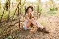 Beautiful young girl with blond hair in a suede jacket with fringed and black felt hat in the countryside on a sunny autumn day Royalty Free Stock Photo