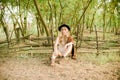 Beautiful young girl with blond hair in a suede jacket with fringed and black felt hat in the countryside on a sunny autumn day Royalty Free Stock Photo