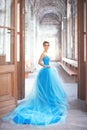 A beautiful young girl in a blue ball dress