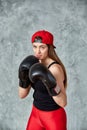 Beautiful young girl boxing gloves near the wall. Royalty Free Stock Photo