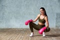 Beautiful young girl boxing gloves near the wall. Royalty Free Stock Photo