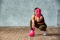 Beautiful young girl boxing gloves near the wall. Royalty Free Stock Photo