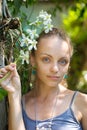 Girl with a branch of a white orchid Royalty Free Stock Photo