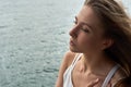 Beautiful young girl with brown hair and awesome eyes on the ocean beach in the metropolis Hong Kong Royalty Free Stock Photo