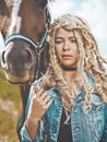 Beautiful young girl with brown horse