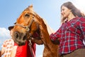 Beautiful young girl with chestnut brown horse