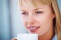 Beautiful young girl with coffee cup. Closeup of pretty woman day dreaming while holding a coffee cup. Royalty Free Stock Photo
