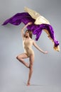 Beautiful young girl dancing. Flowing fabric. The girl throws a colorful fabric. Fabric is flying