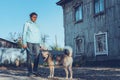 Beautiful young girl with a dog, on the background of an old house. The concept of buying a new home, an animal shelter Royalty Free Stock Photo